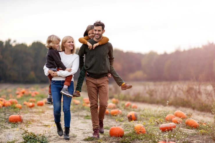 family in pumpkin patch