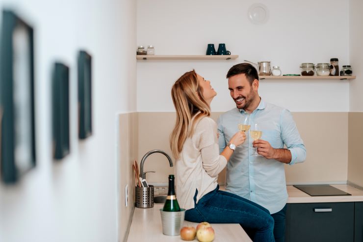 couple drinking wine kitchen stock